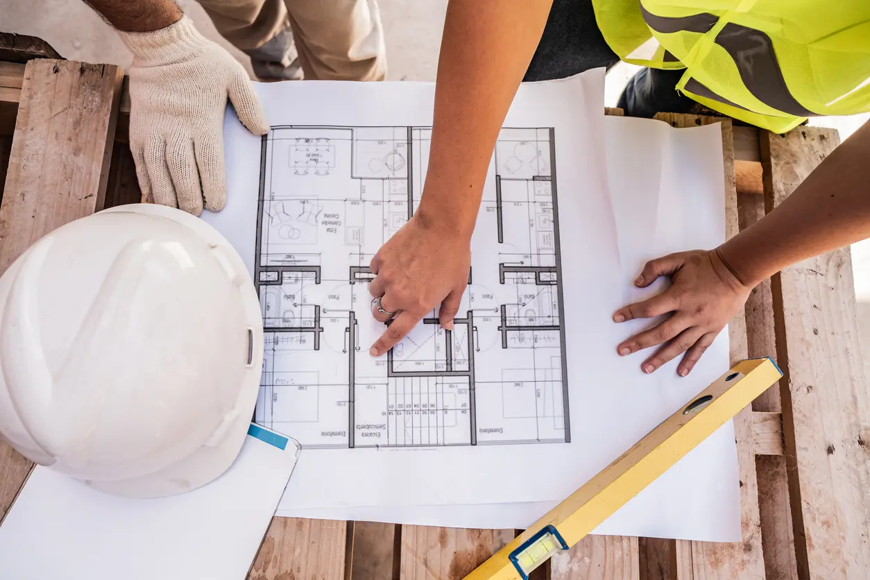Builders reviewing custom home design blueprints in Prescott AZ