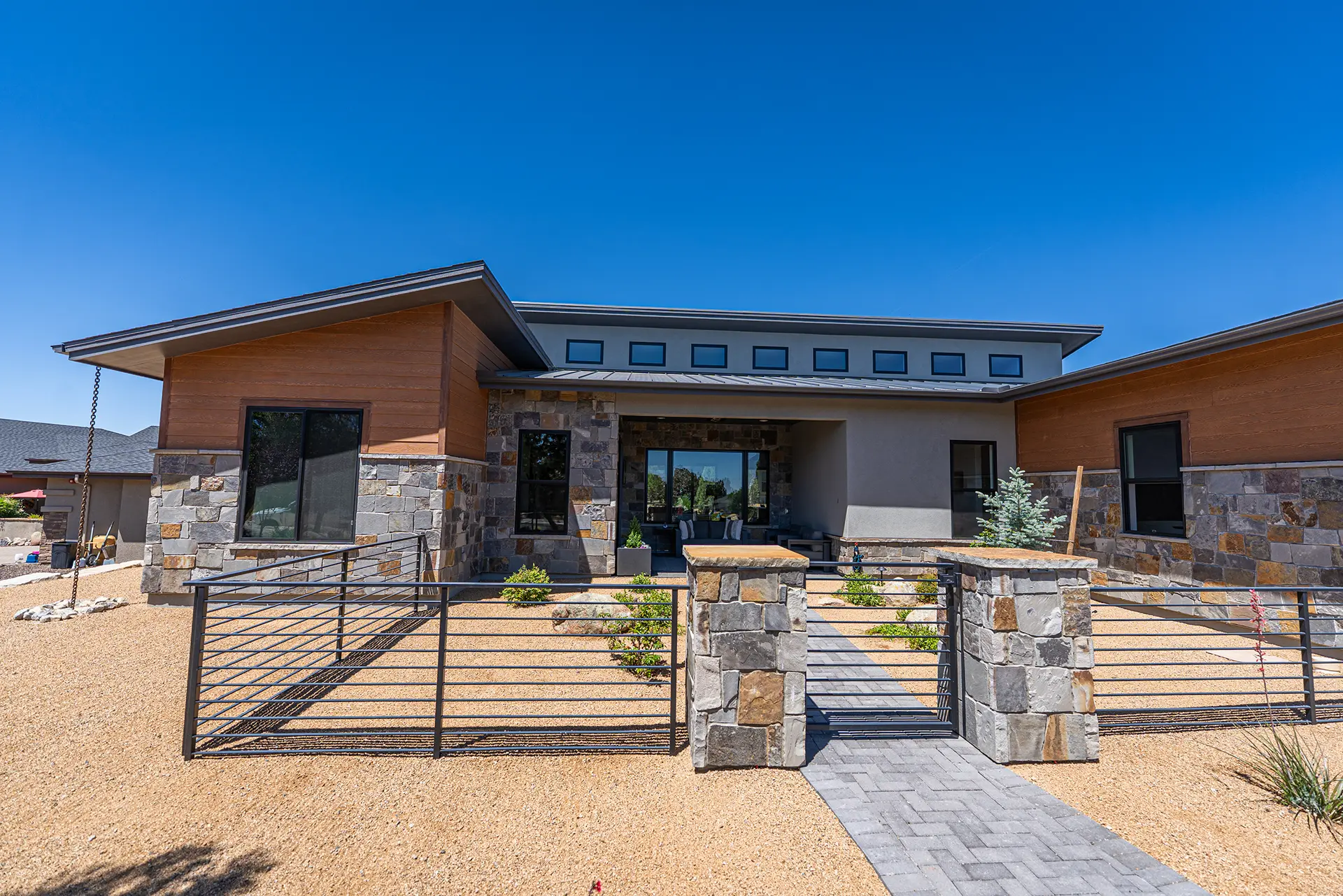 Modern custom home built by a custom home builder in Prescott with stone accents and desert landscaping