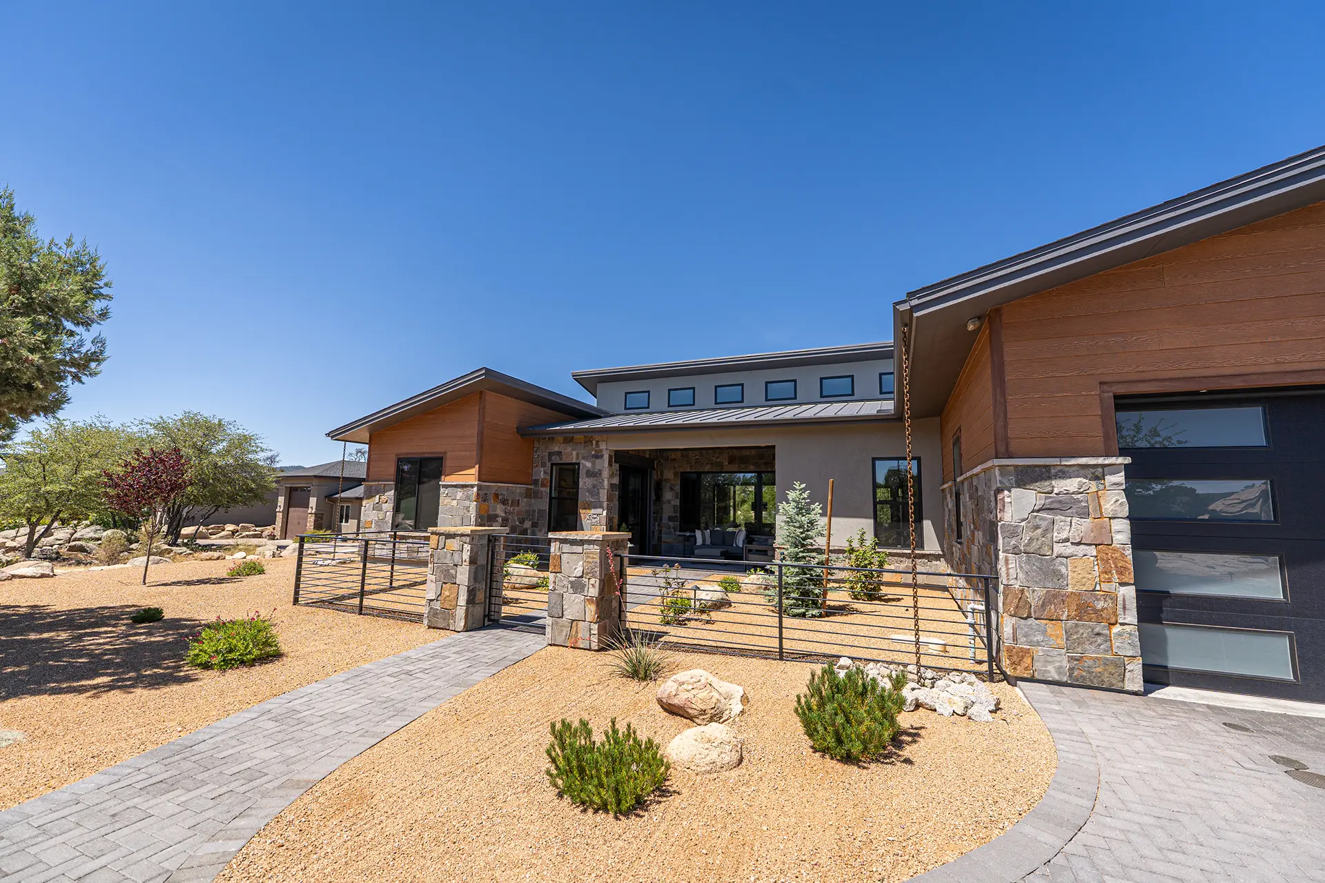 Modern custom residence showcasing new home construction Prescott AZ with stone accents and desert landscaping