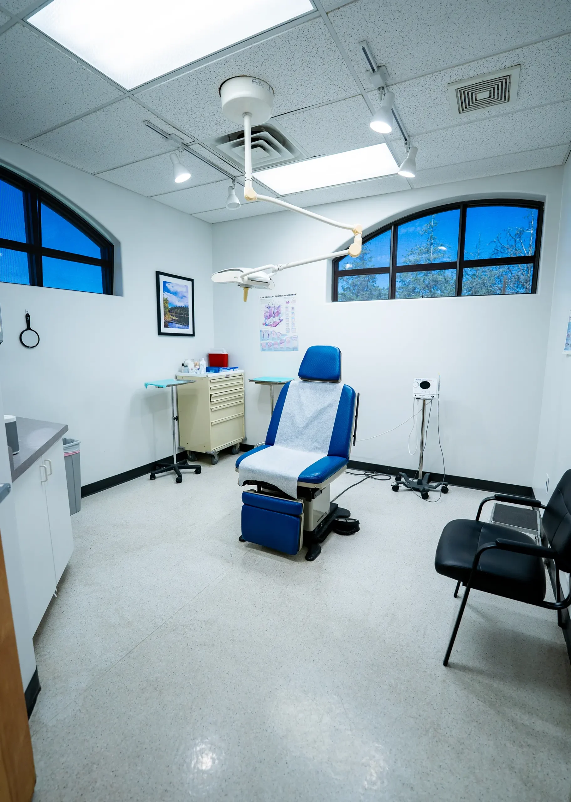 Modern Medical Examination Room Prescott AZ Modern medical examination room by a custom home builder in Prescott AZ with patient chair and clinical lighting